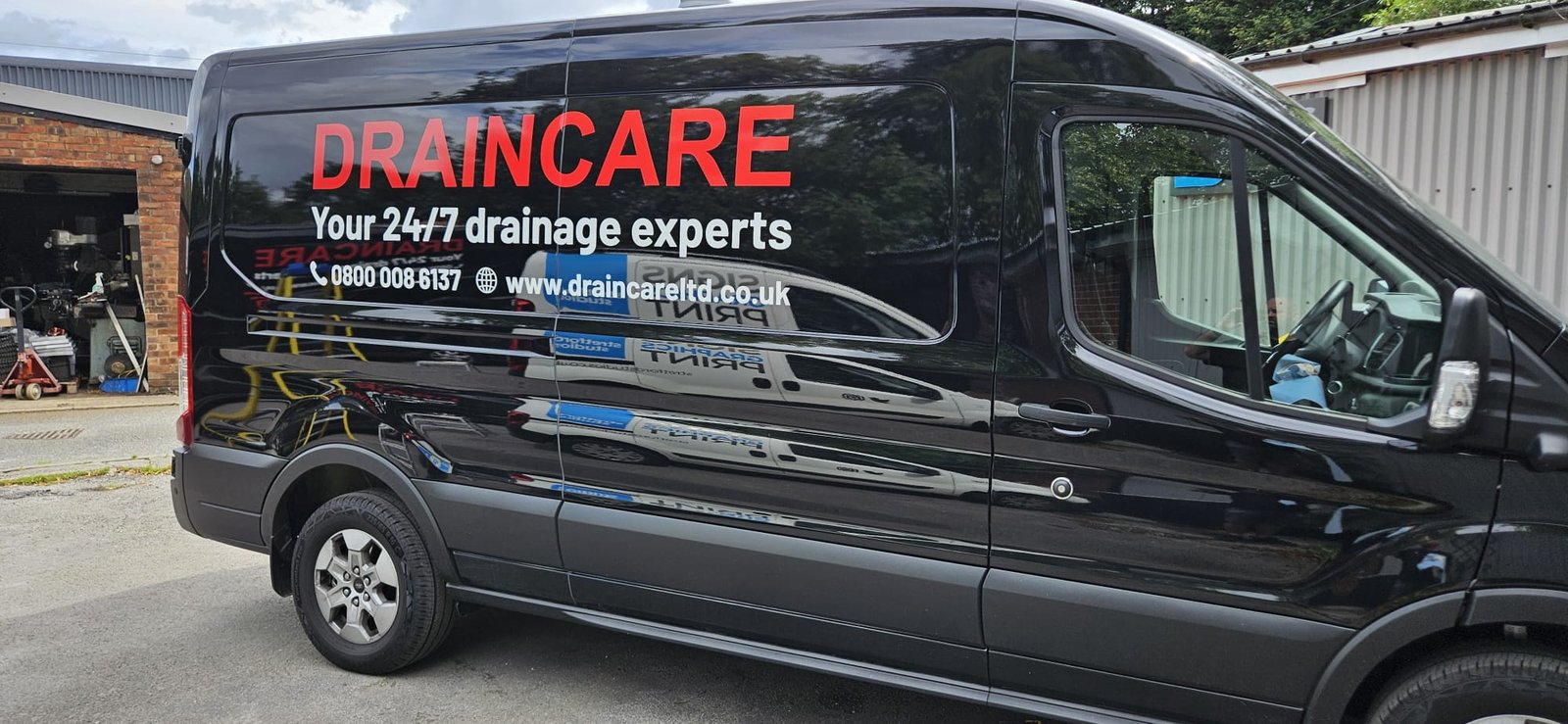 Draincare vehicle livery — close-up of van graphics and branding