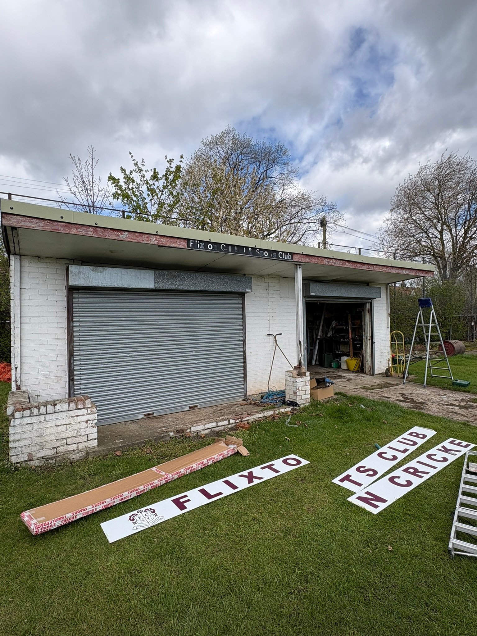 Flixton Cricket Club signage — signs laid out ready for installation on site