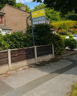 Locate For Sale board with a grey post coordinated with the estate agent’s branding